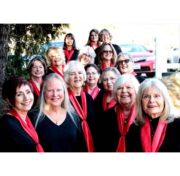Mountain Melody Chorus group photo wearing black top and red scarf